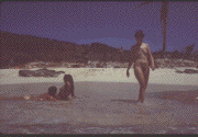 [A nude woman walking into the ocean.]